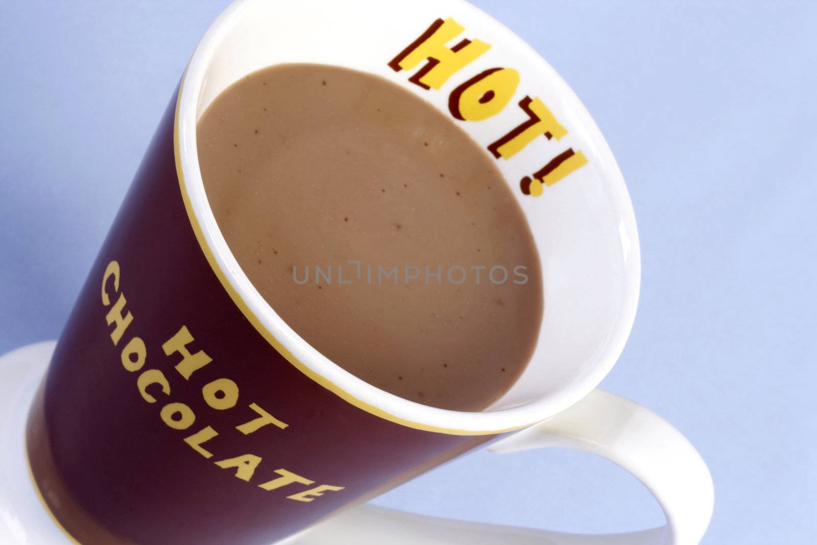 A mug of hot chocolate over light blue background