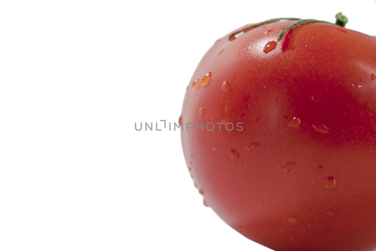 fresh red tomatoes in a heap on a light background