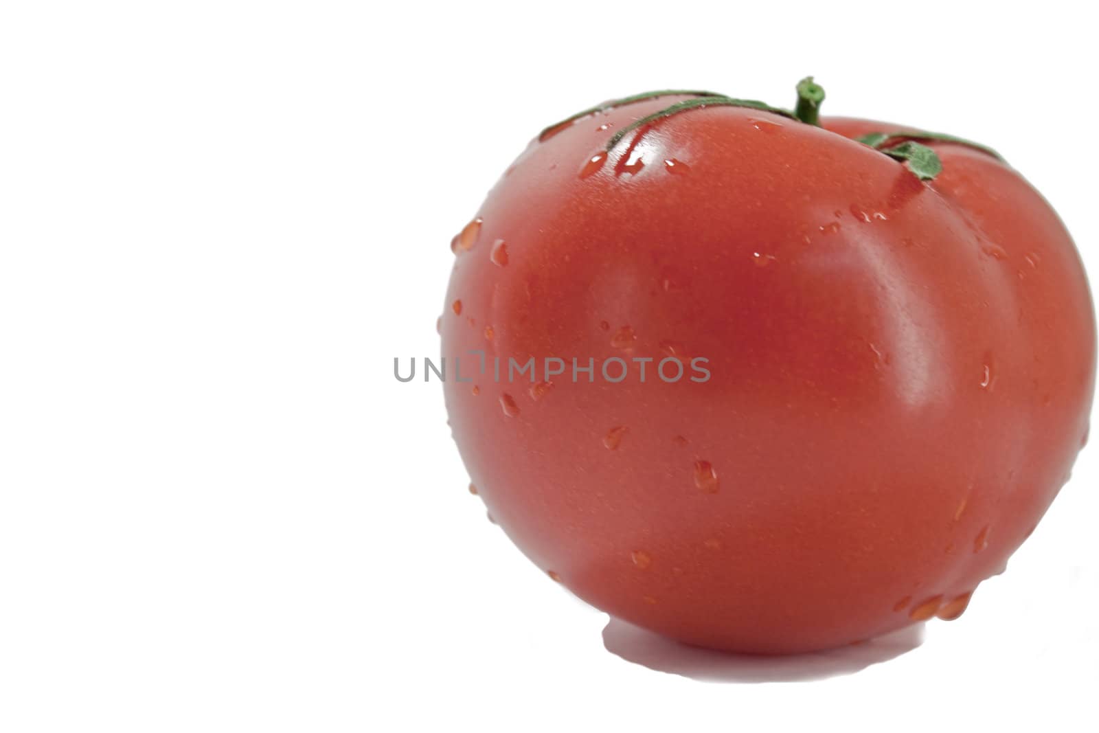 fresh red tomatoes in a heap on a light background
