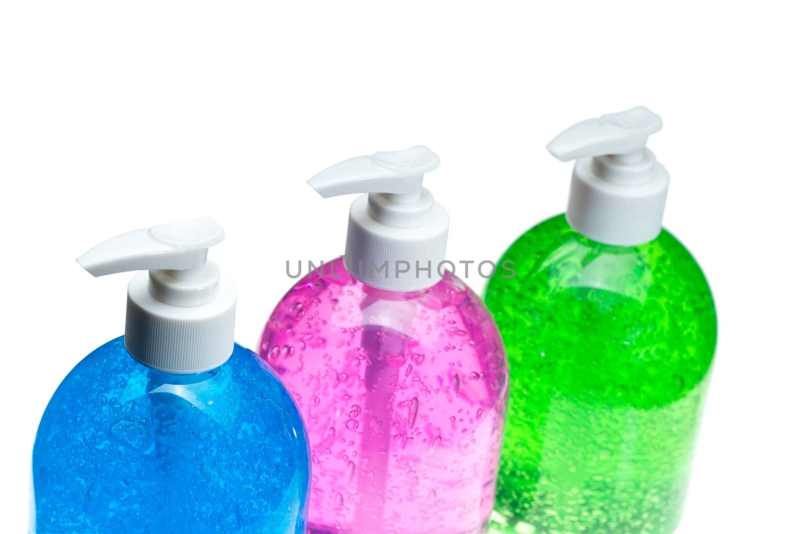 colorfull blue,pink and green hair gel bottles over white background