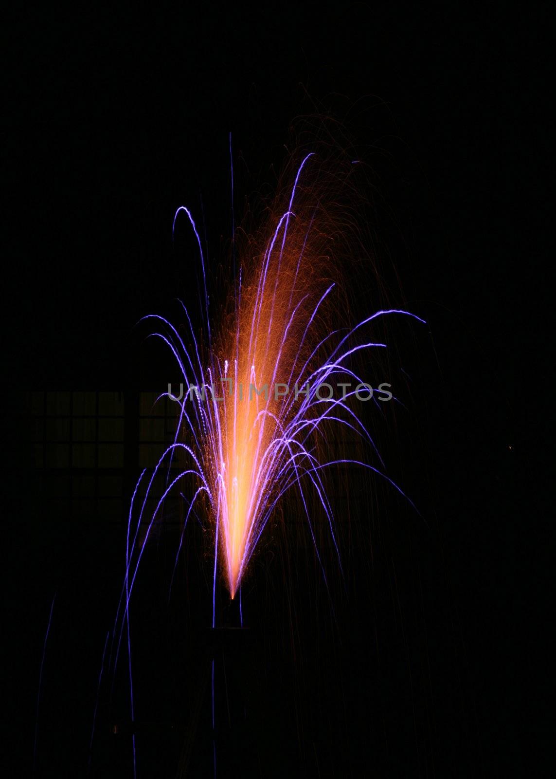 Wonderful spouting fireworks display shooting off from the top of a ladder
