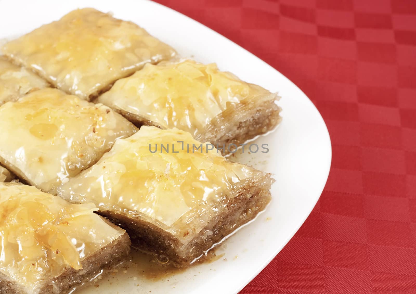 Traditional Turkish dessert Baklava - served in white porcelain dish