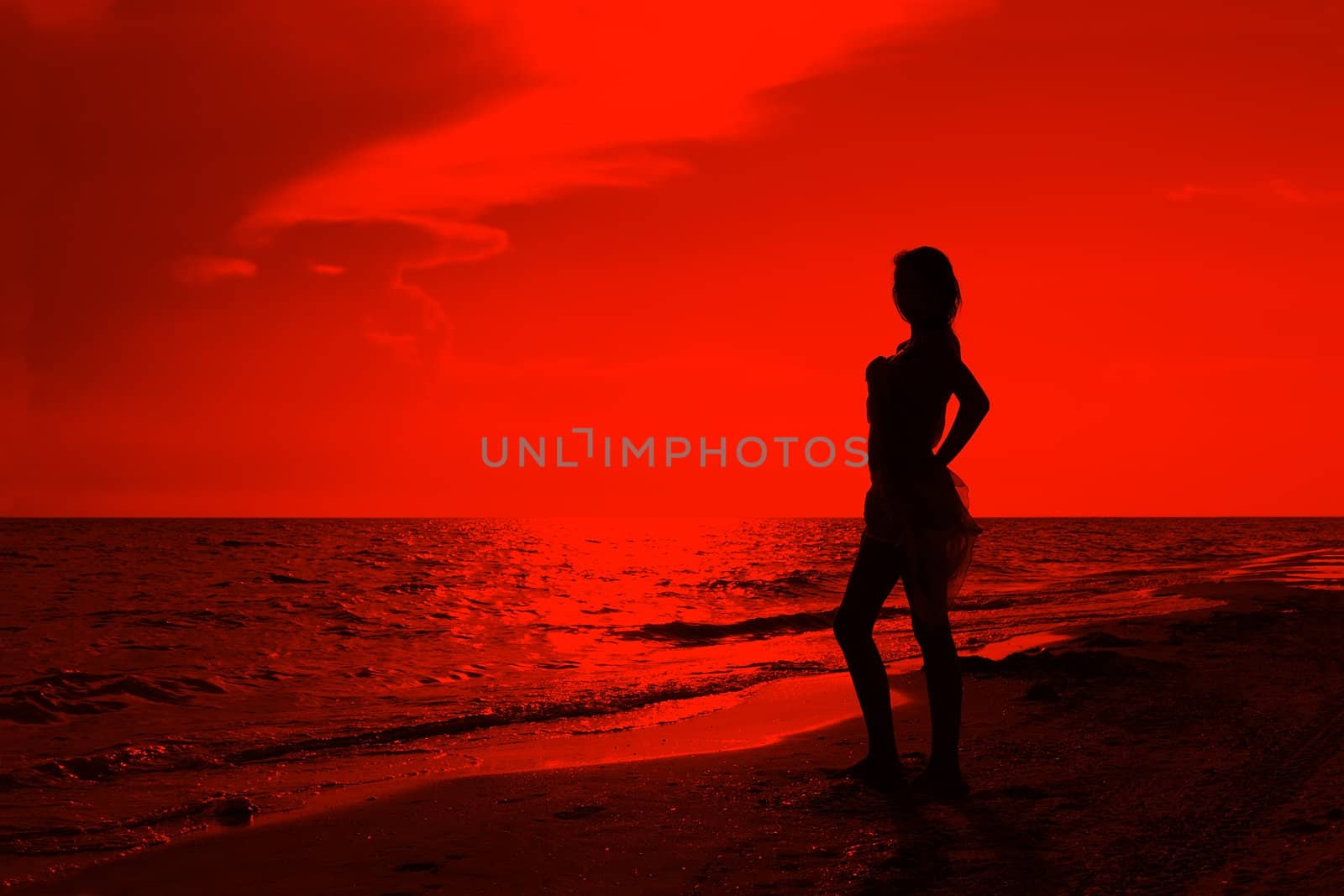 Teenage girl on the beach at sunset. Processed Editor