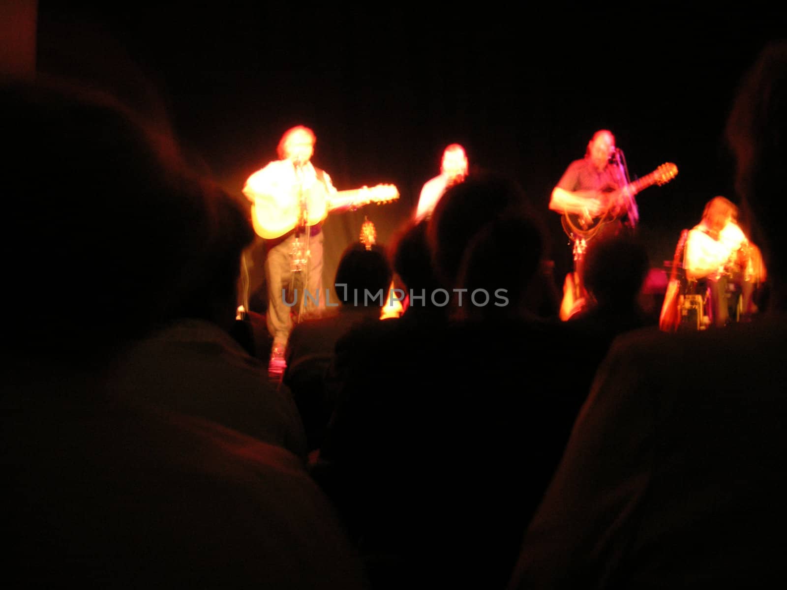 blurred group as they perform on stage