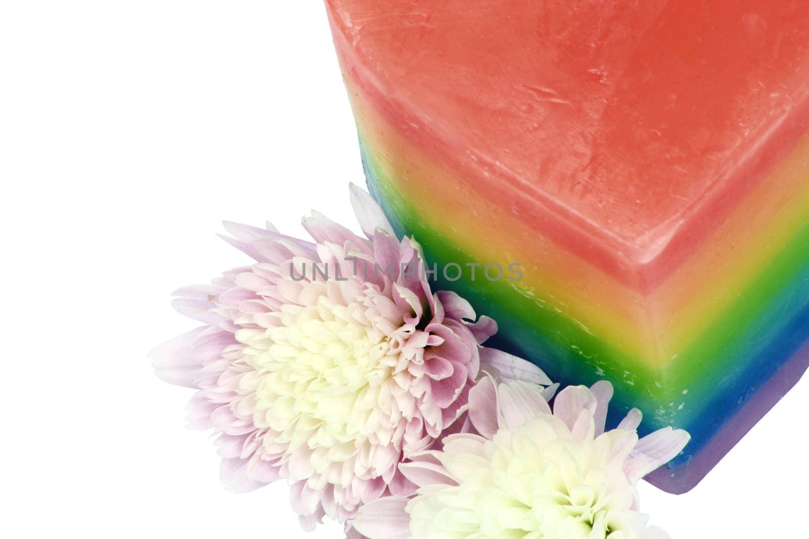 multi coloured candle with flowers against a white background