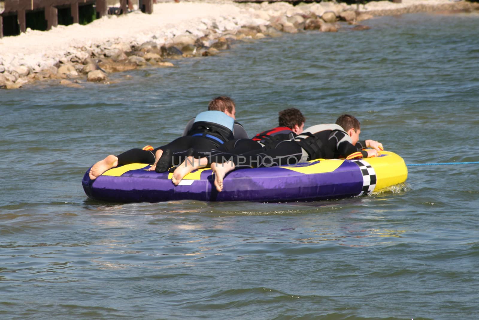 men having fun on a water float by leafy