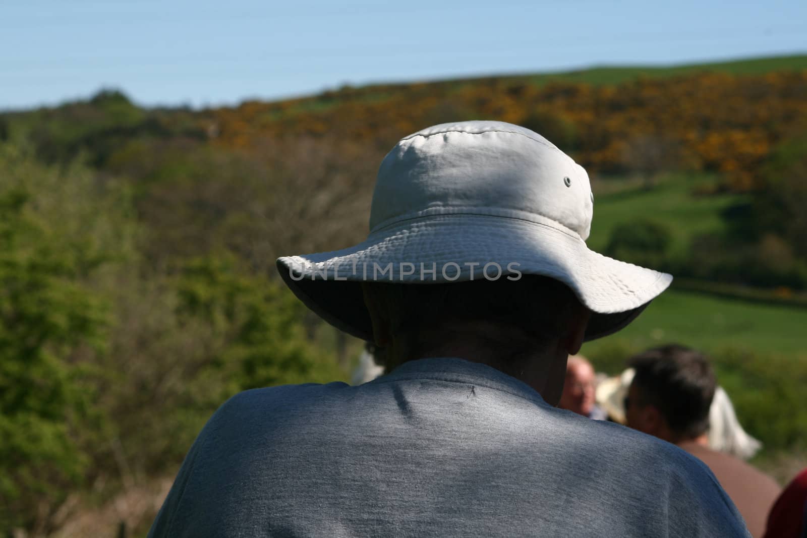 a sun hat for protection against the sun keeping this man in the shade