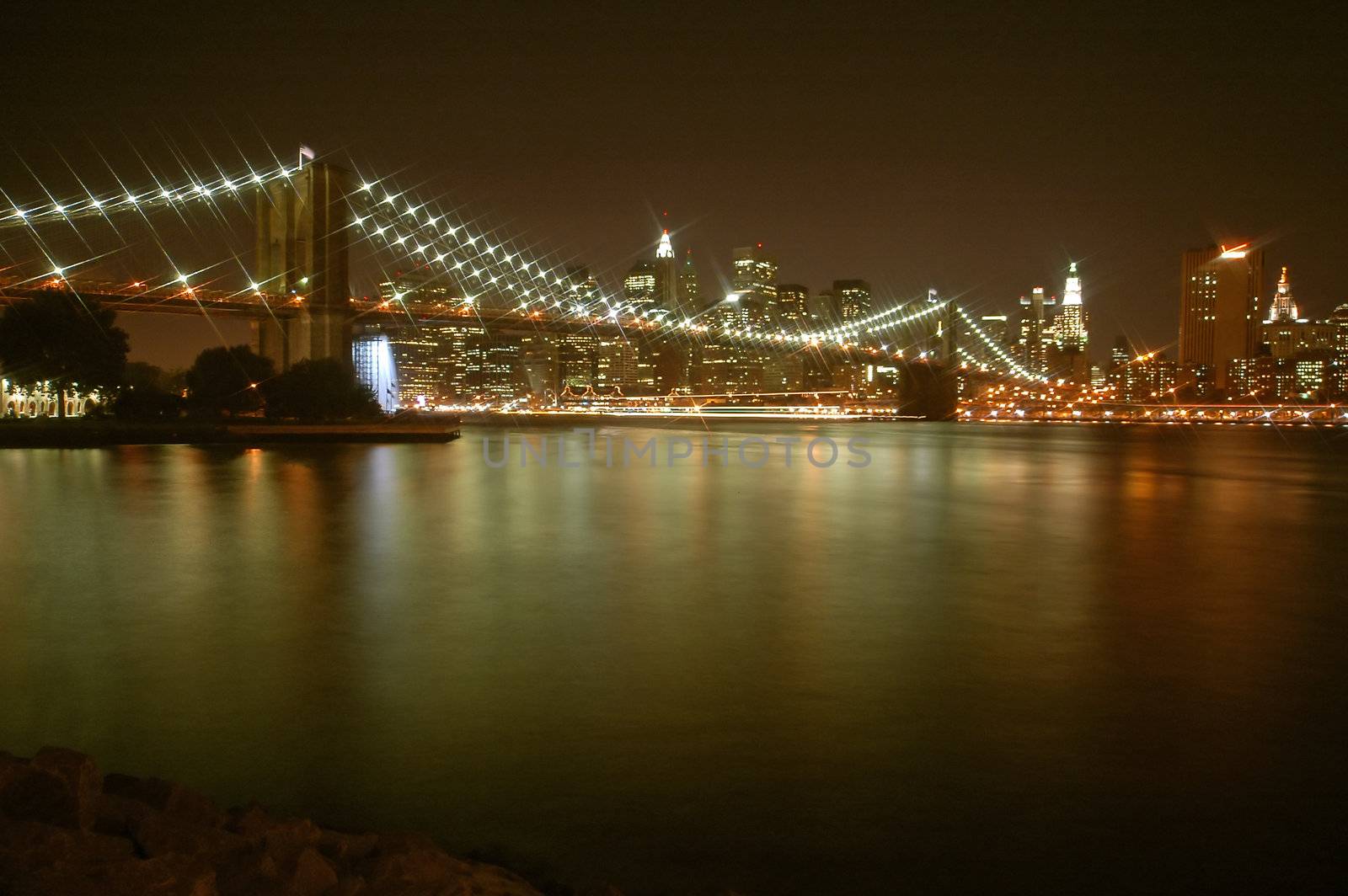 manhattan night scene, lighted brooklyn bridge, reflection in water