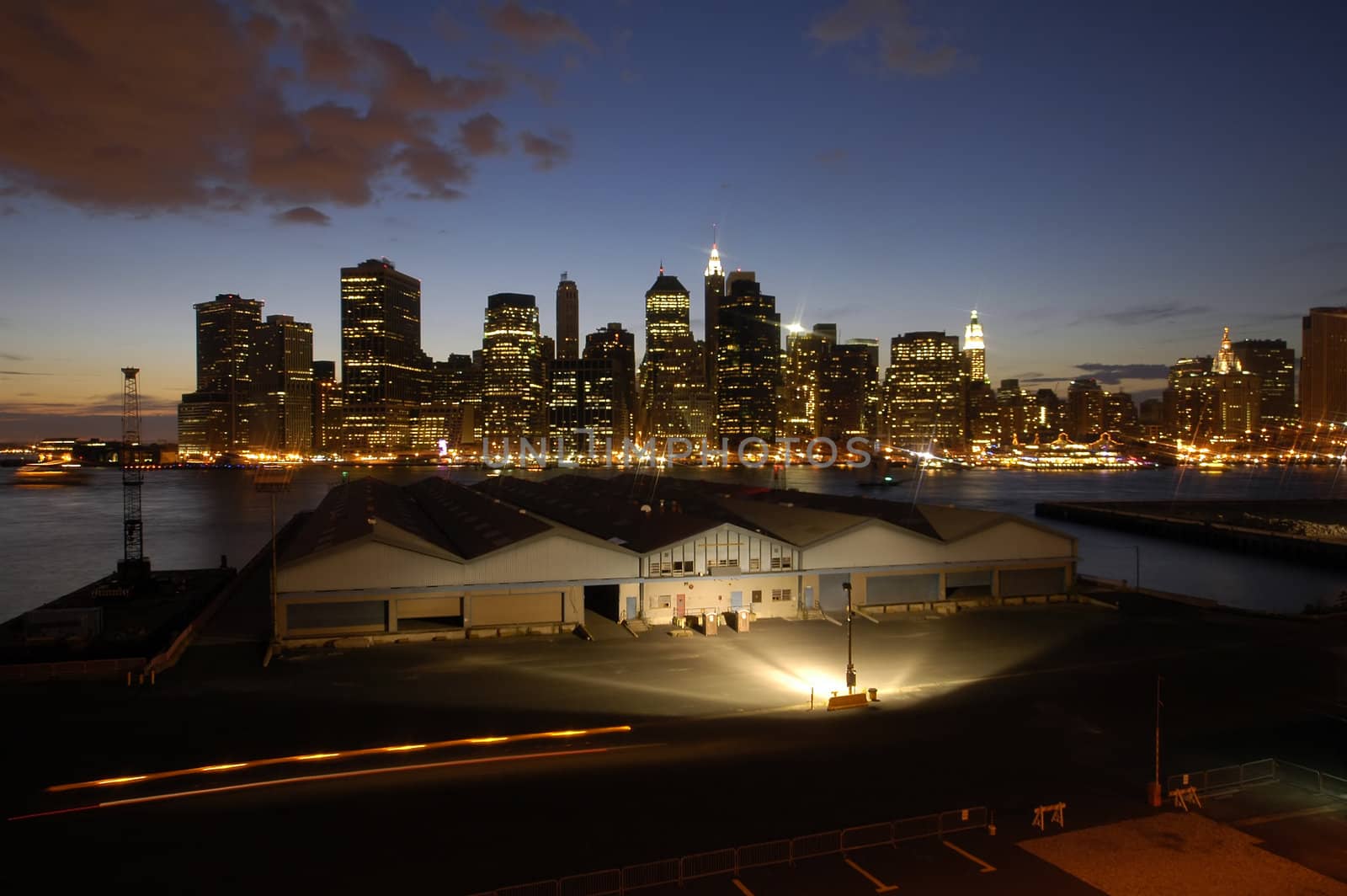 night photo of lower manhattan, some brooklyn warehouse in front,
