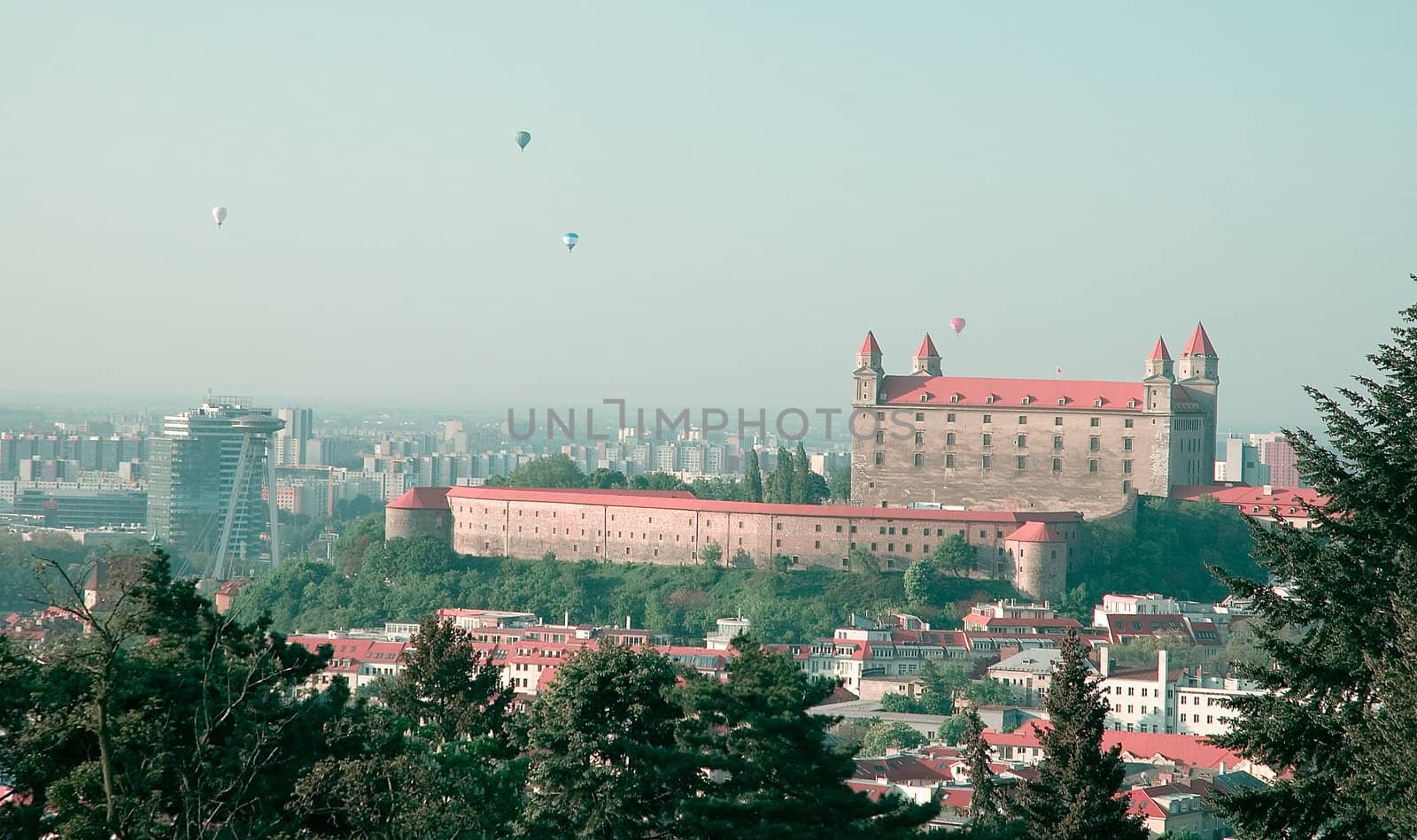 famous bratislava castle, flying balloons in background, cold autumn colors