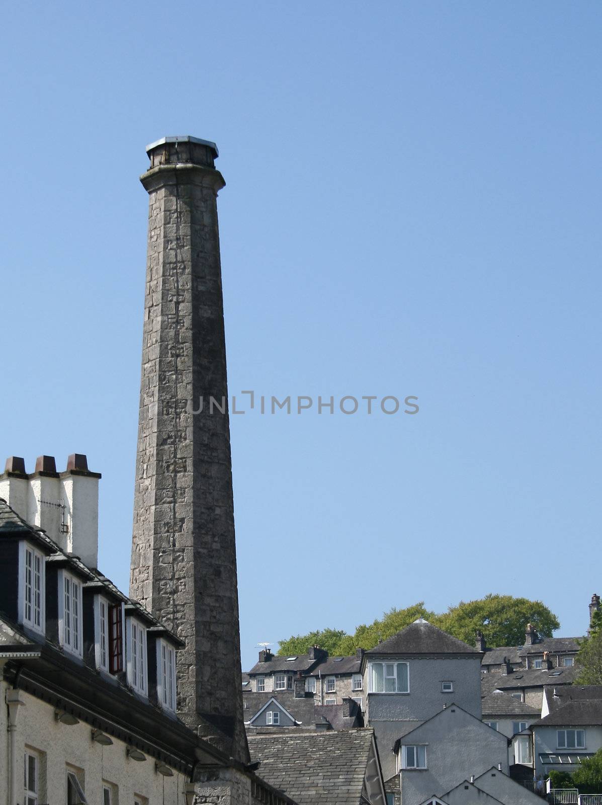 large industrial chimney by leafy