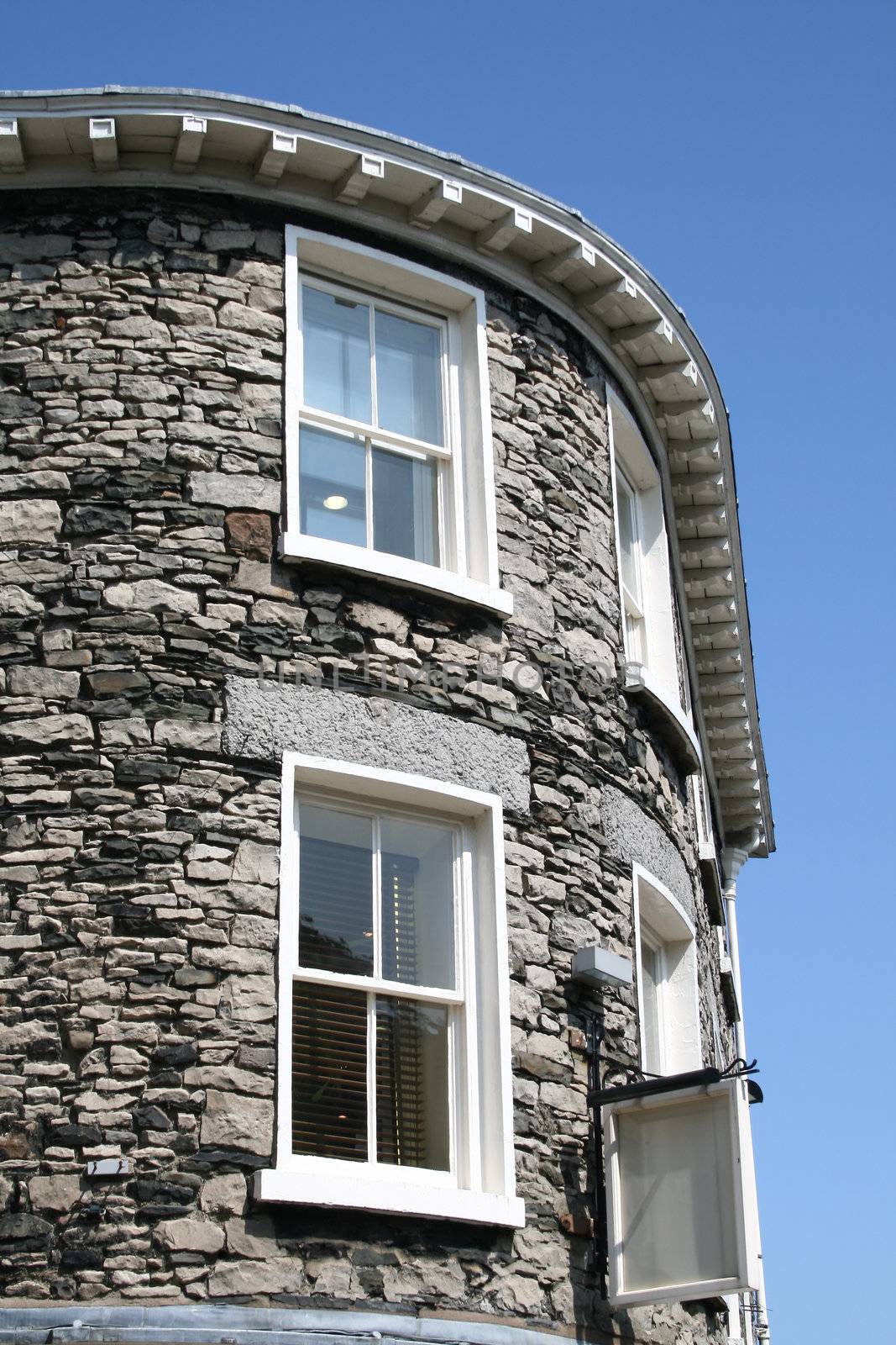 old architure detail showing windows against a blue sky