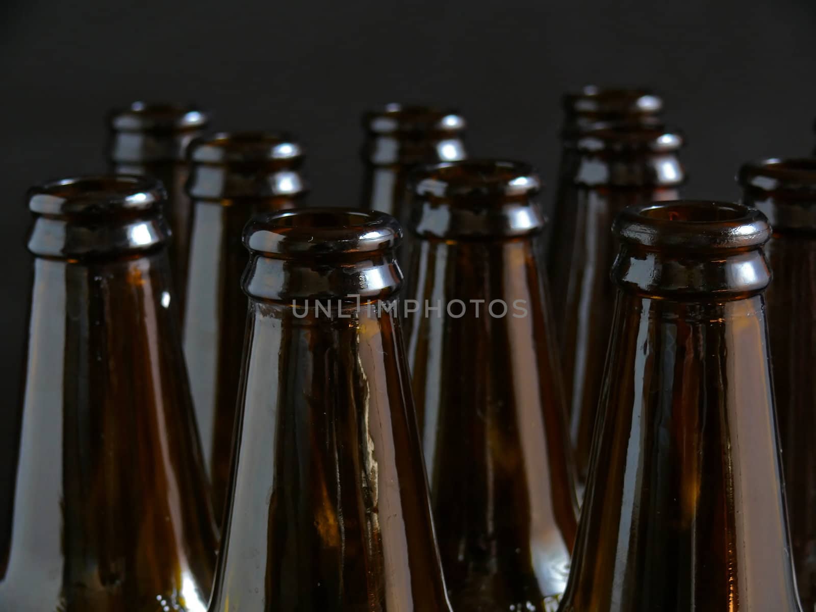 a few brown bottles on black background