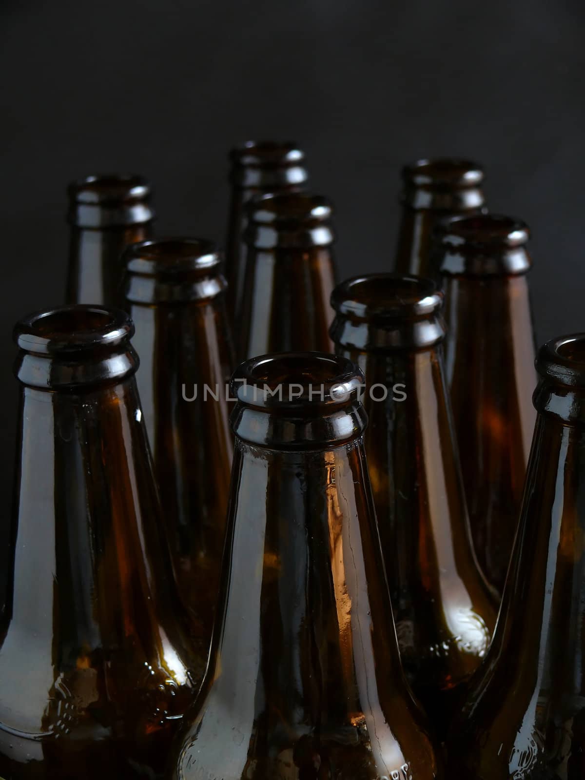a few brown bottles on black background