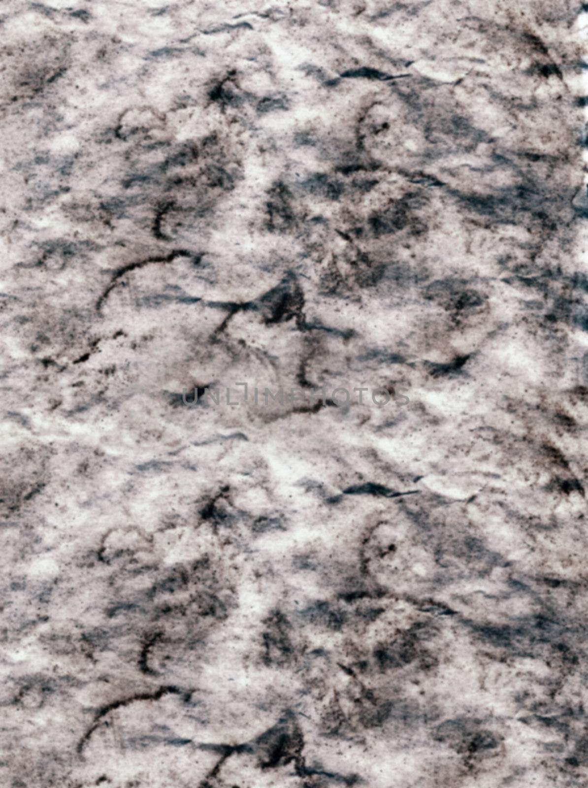 grey grunge background of paper which is blotchy
