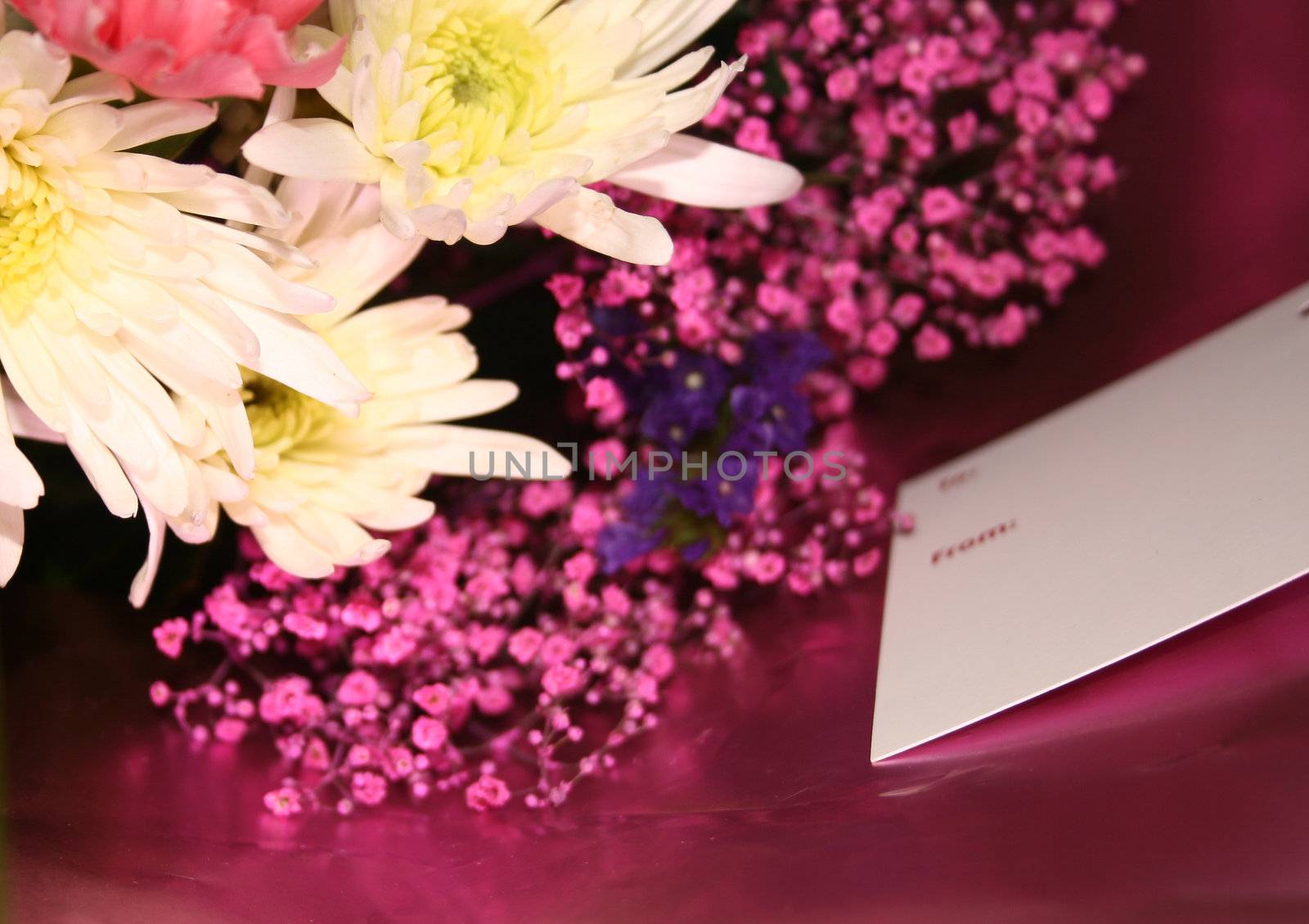 blank card on a bouquet of flowers  