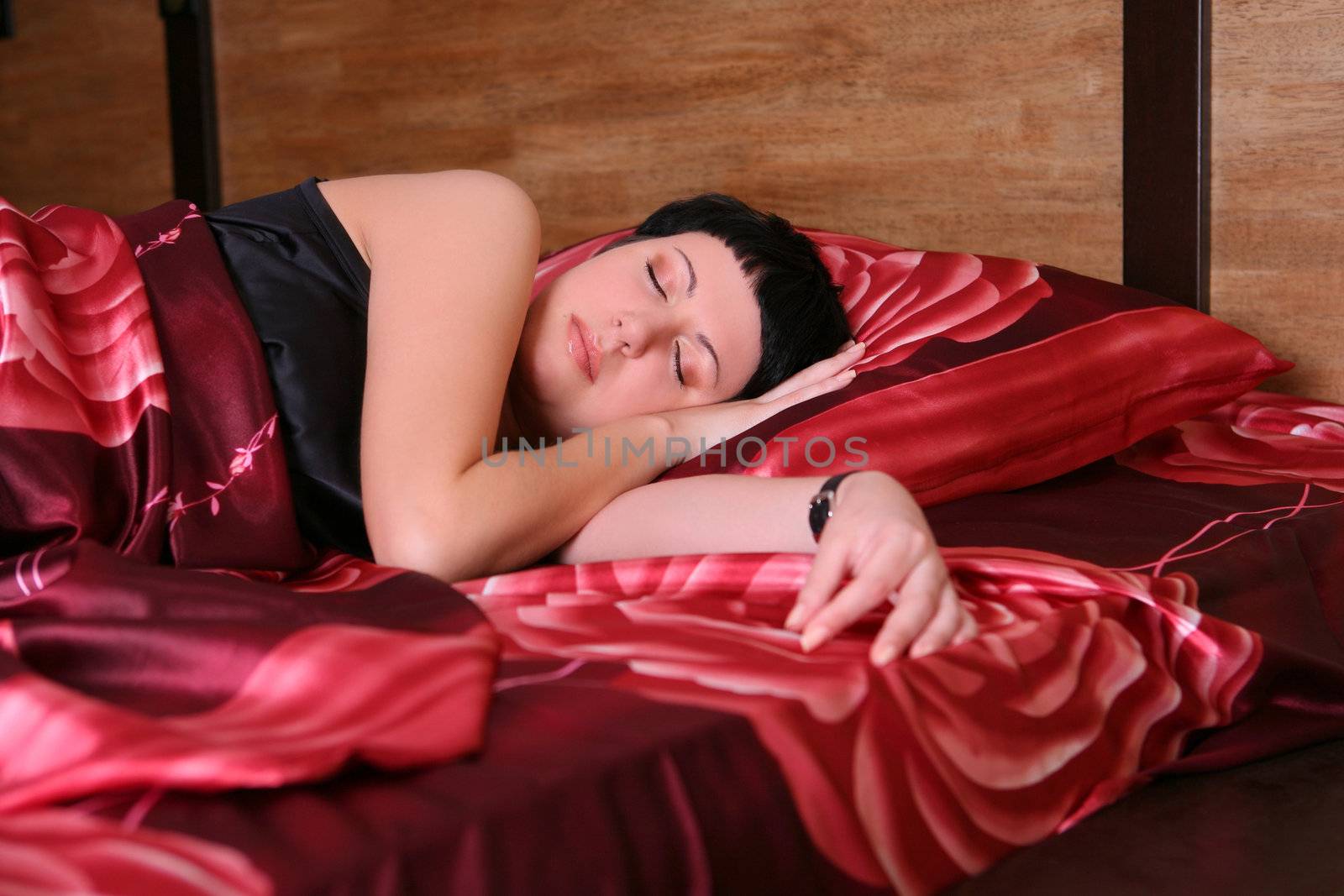 Young woman is sleeping in the bed