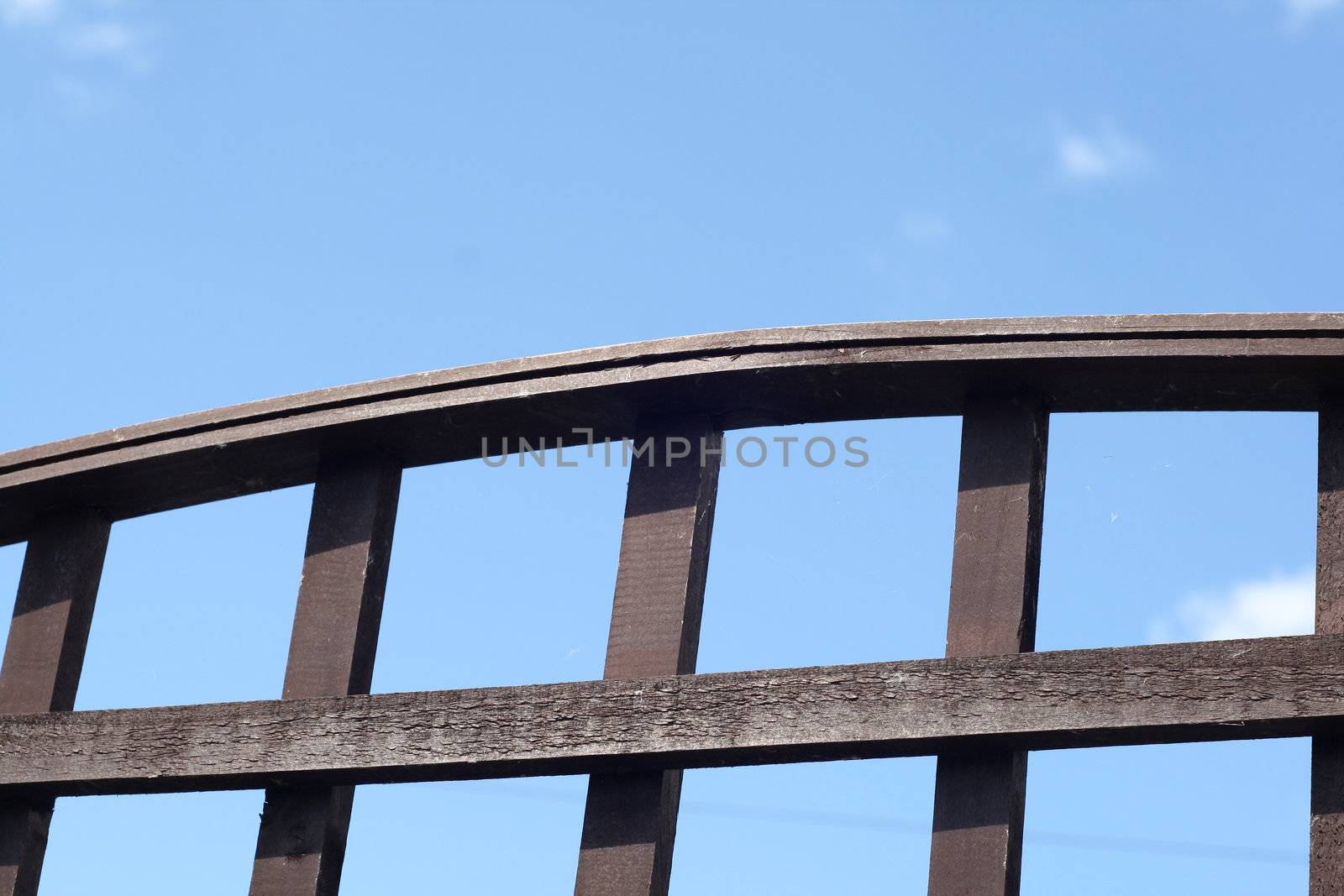 wooden trellis set against a blue sky
