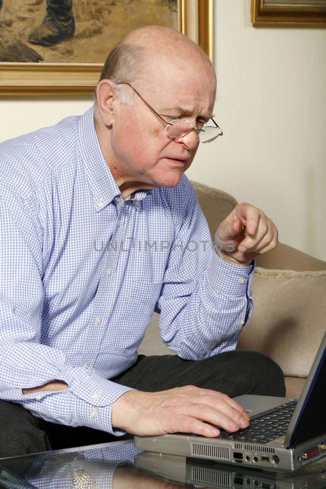 happy old  senior man with laptop at home