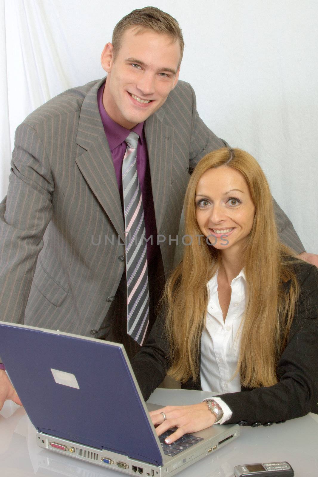 a happy business team at work- two persons