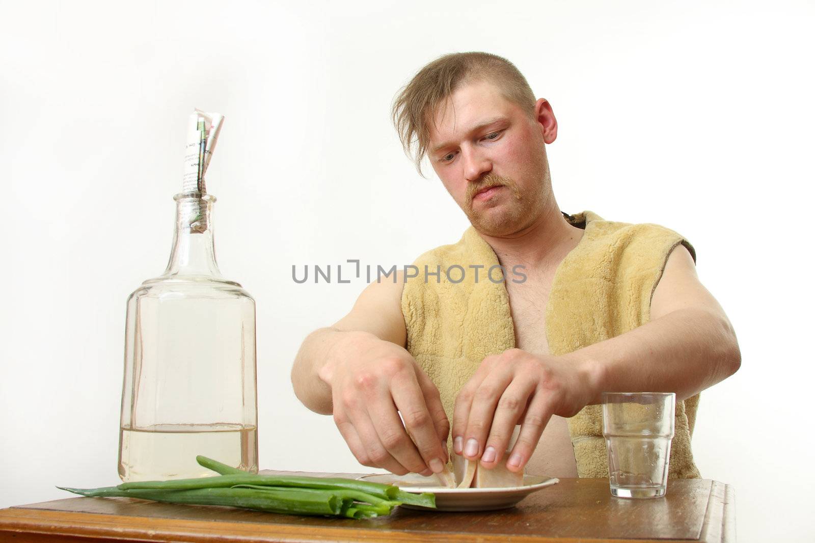 The man drinks moonshine and has a snack fat and an onions