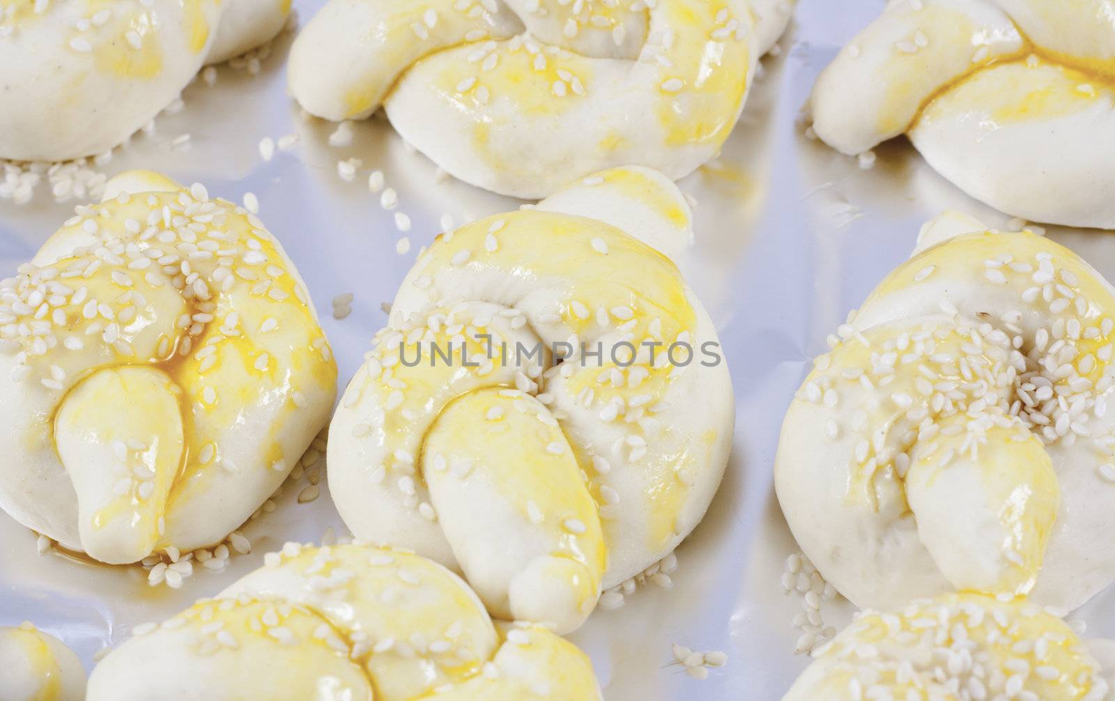 Buns on aluminum foil prepared for baking