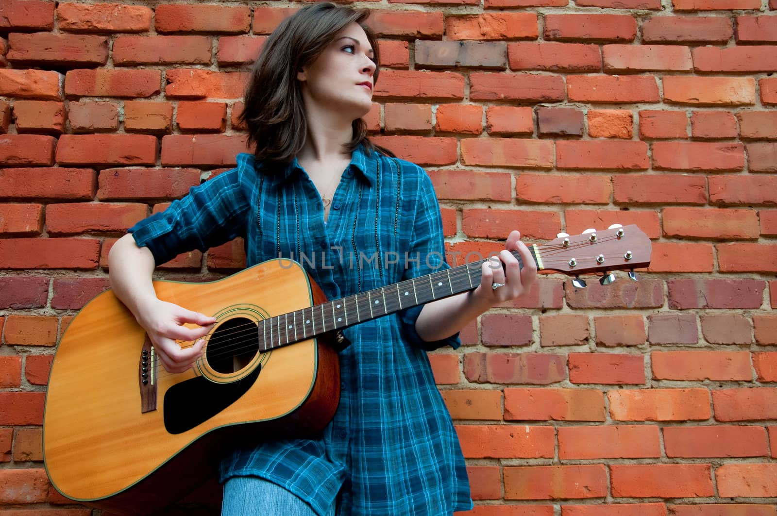 Young Brunette Female  Playing Guitar by dehooks