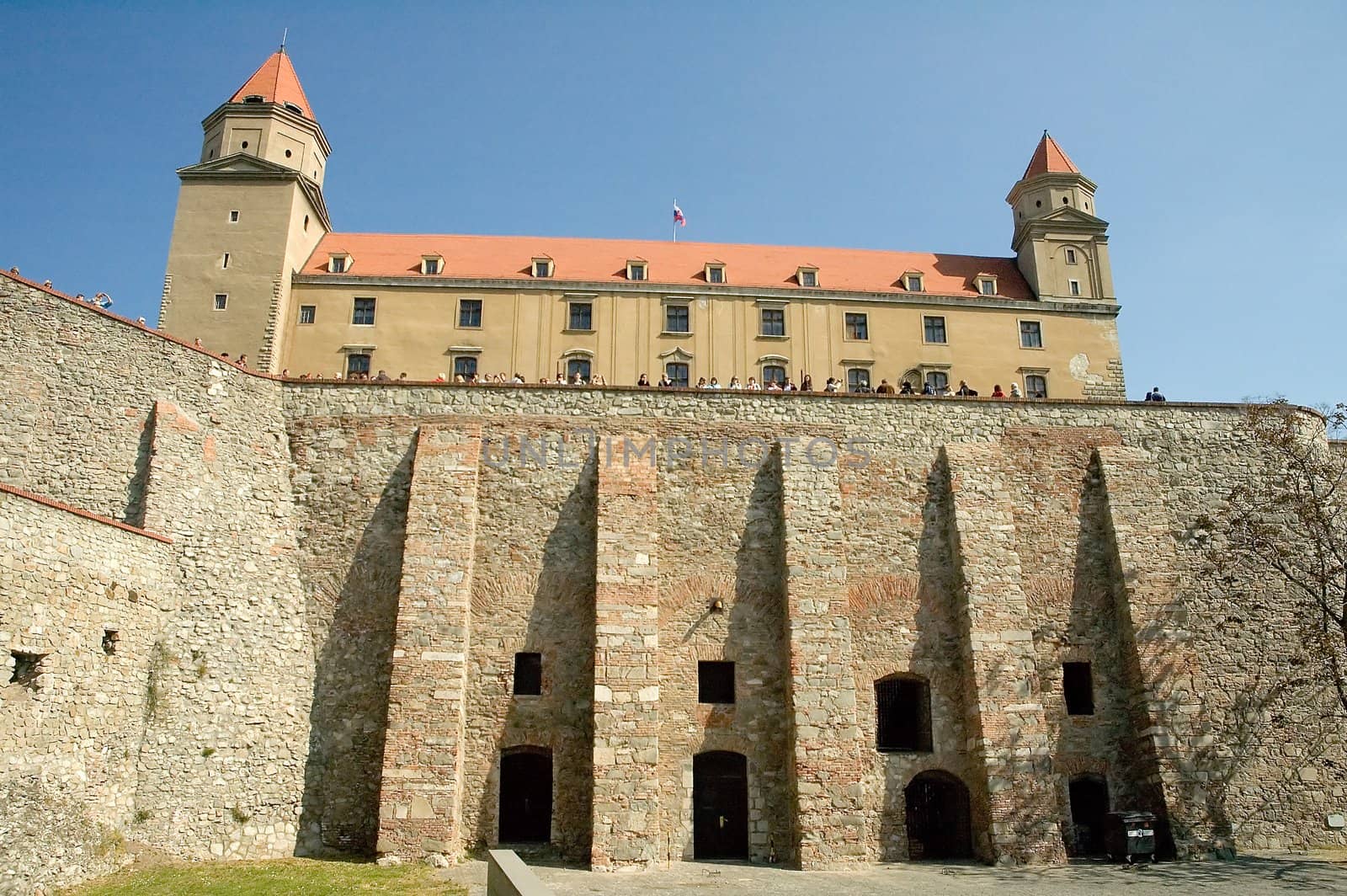 bratislava castle, several tourists, photo taken under city walls