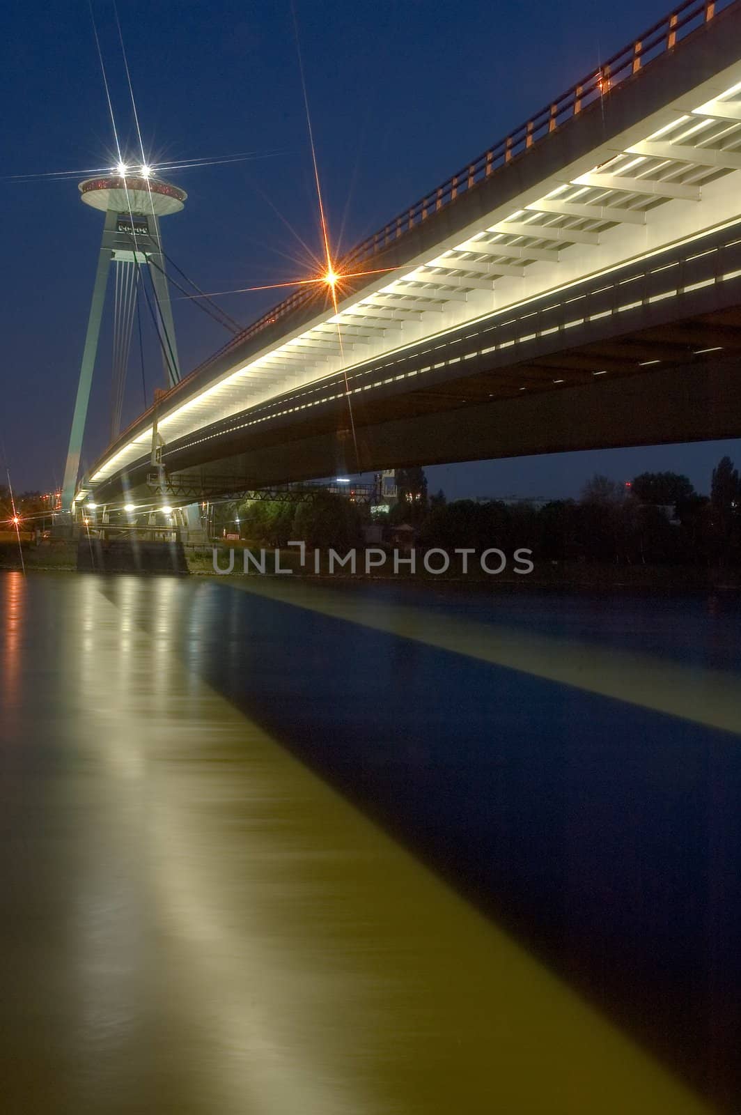 night photo of new bridge in bratislava, restaurant on top of the bridge