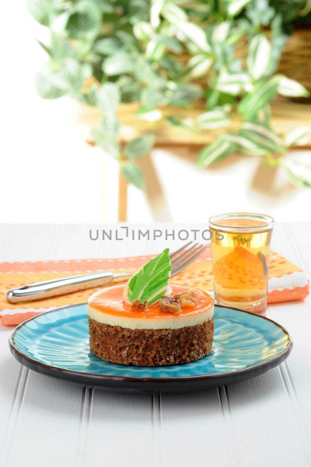 An individual serving of carrot cake on a blue plate.