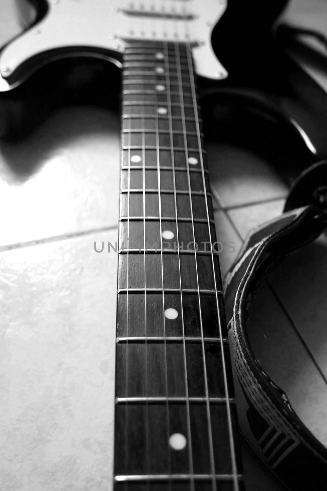 Black and white close up of neck of guitar