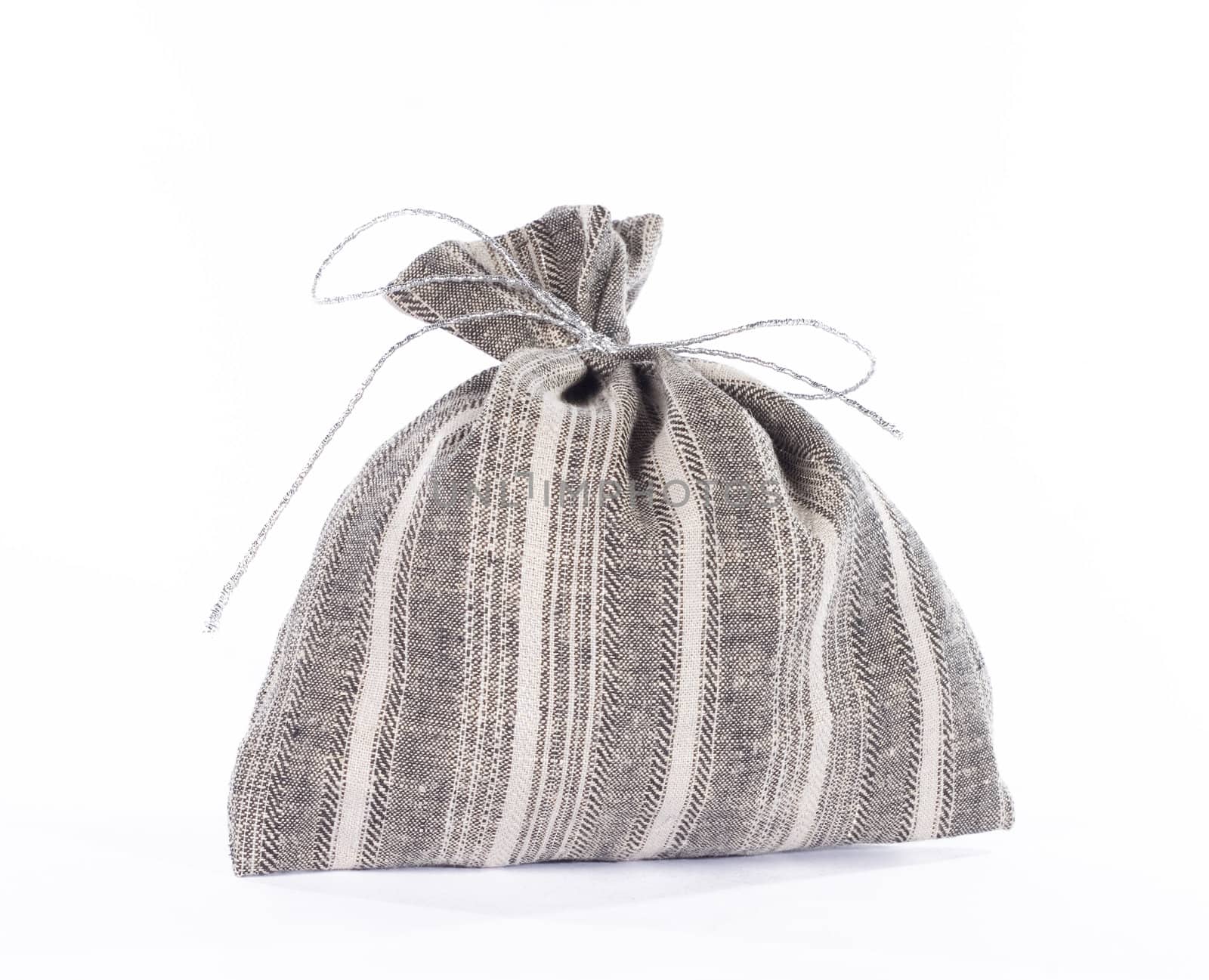 Traditional style linen textile grey gift bag over white background.