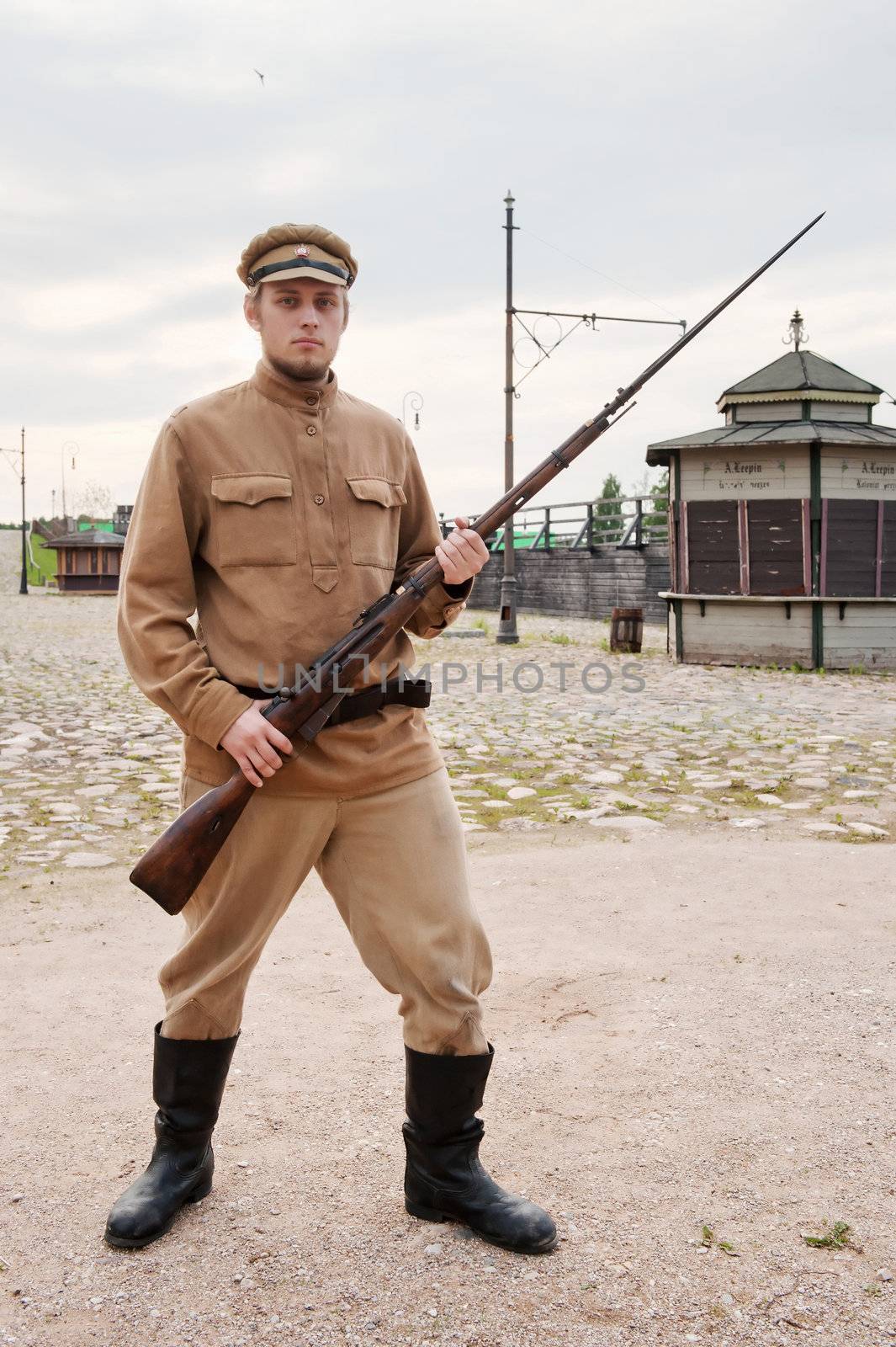 Soldier with a gun in uniform of World War I. Costume accord the times of World War I. Photo made at cinema city Cinevilla in Latvia.