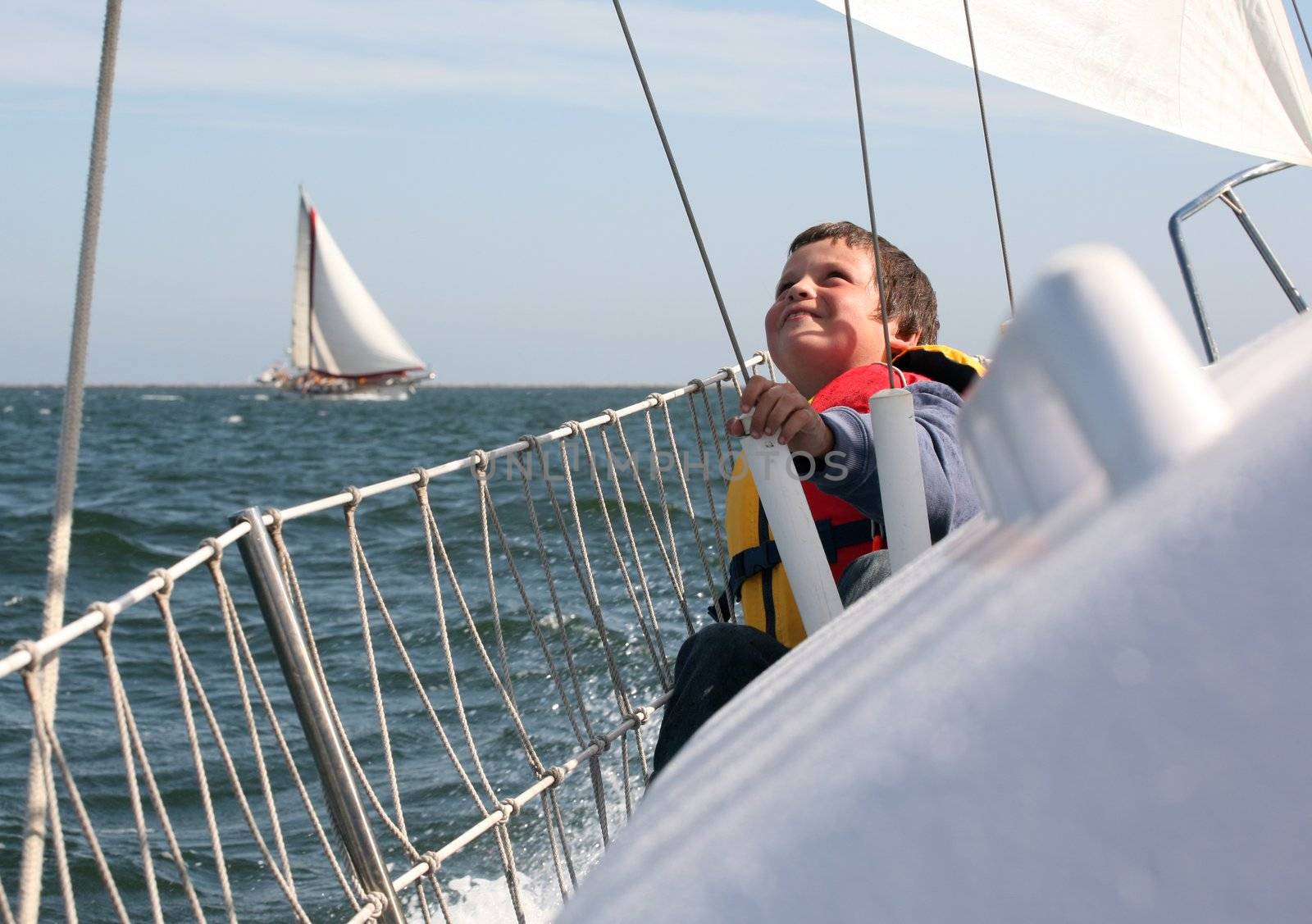 Young boy with ocean spray on him showing his joy of sailing