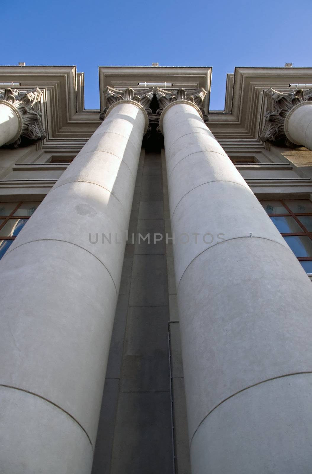 Stalinist architecture. Corinthian capitals and columns. Prospectively on a background of blue sky.