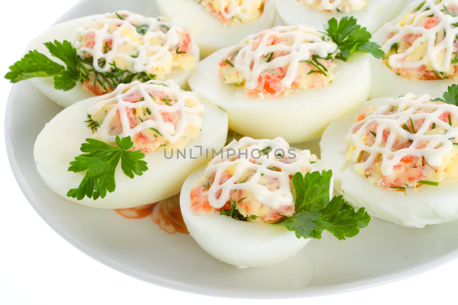 close-up stuffed eggs with red fish, view from above, isolated on white