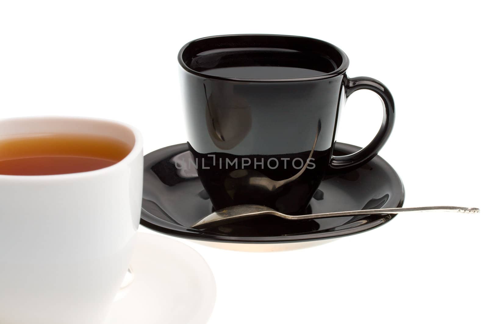 close-up white and black cups with tea by Alekcey