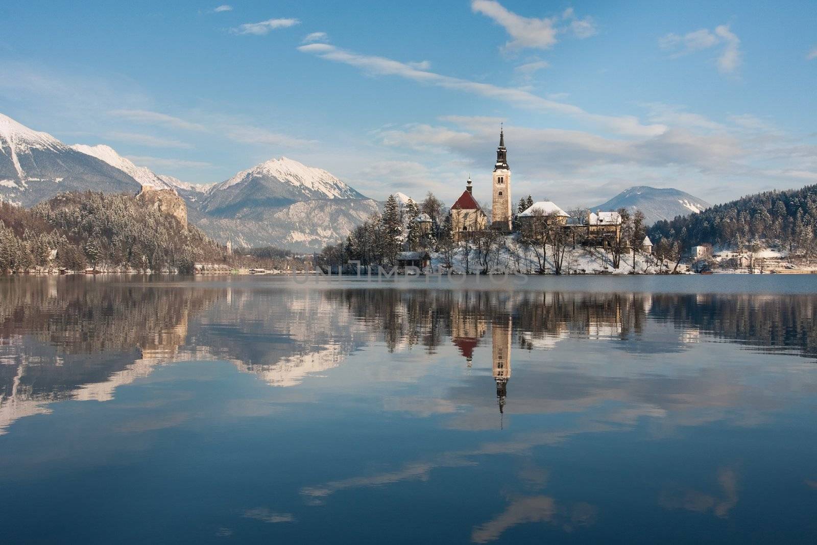 View on lake Bled with small island with church and castle on rock in Slovenia, Europe.
