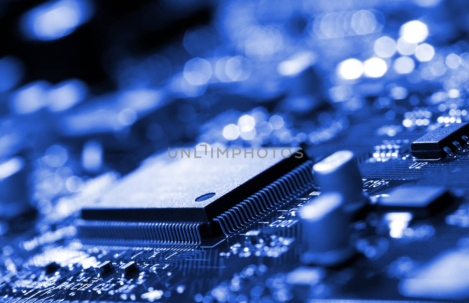 microchip on blue circuit board by Alekcey