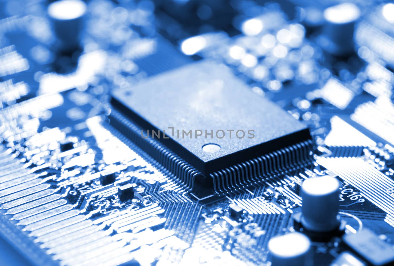 close-up microchip on circuit board, blue toning
