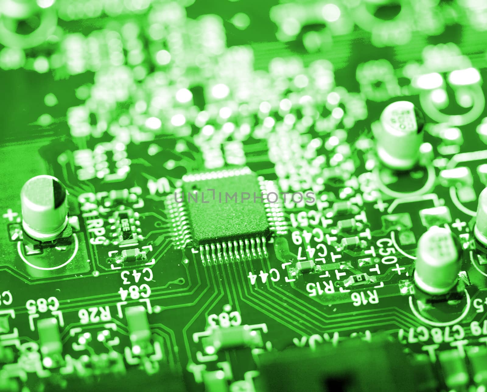 close-up microchip on green circuit board