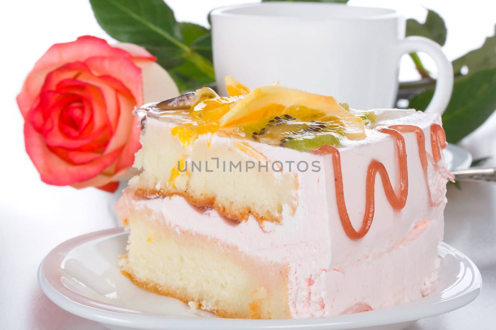 piece of cake with fruits rose and cup, isolated on white