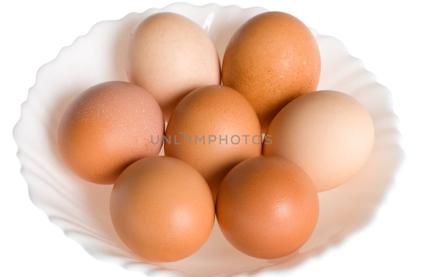 seven eggs on plate, isolated over white