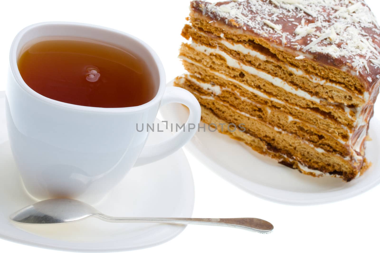 tea cup and piece of honey cake, isolated on white