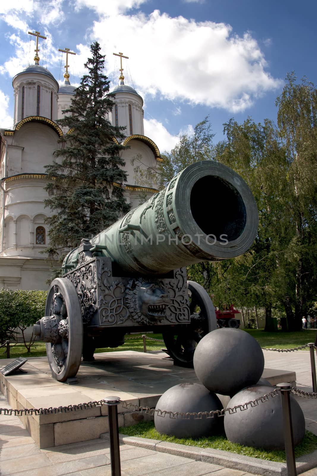 Historic canon and balls in front of a church at the Kremlin. by Claudine