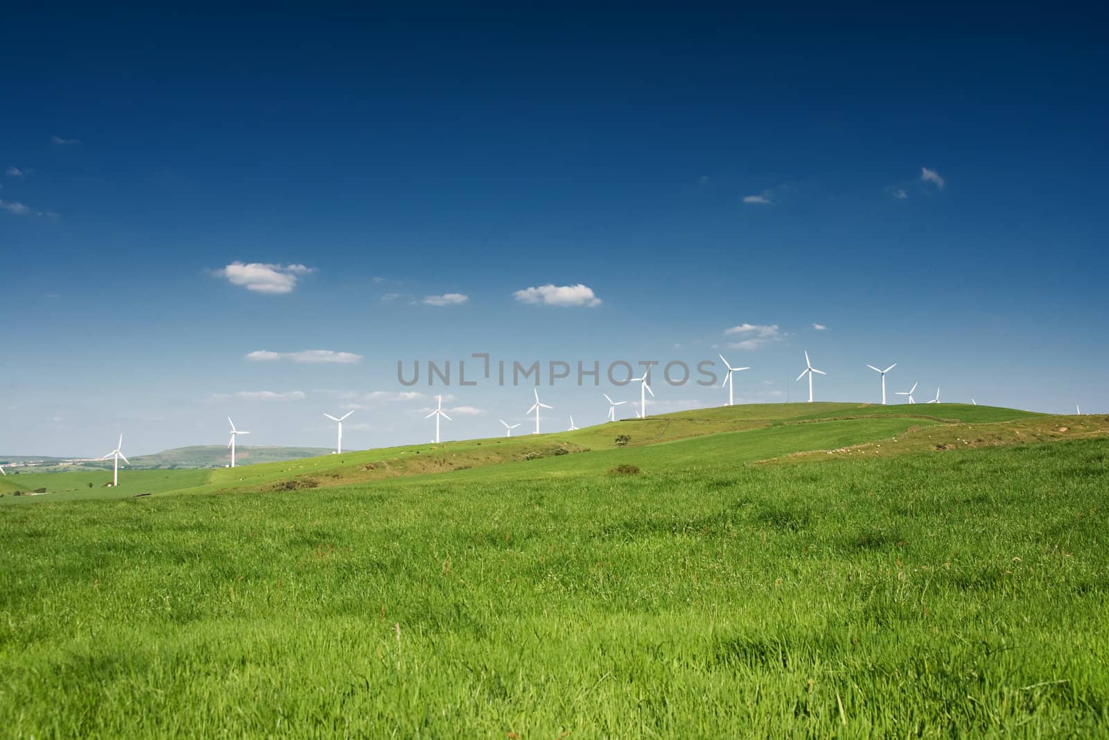 Wind turbines farm on the hills in Wales, UK. Alternative energy source. 