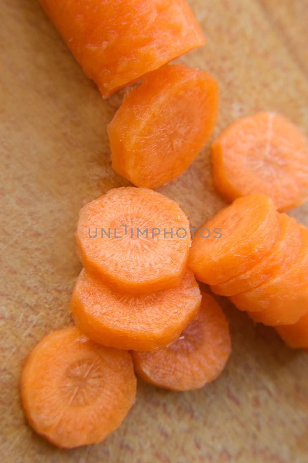 Chopped carrot in circle on wooden board