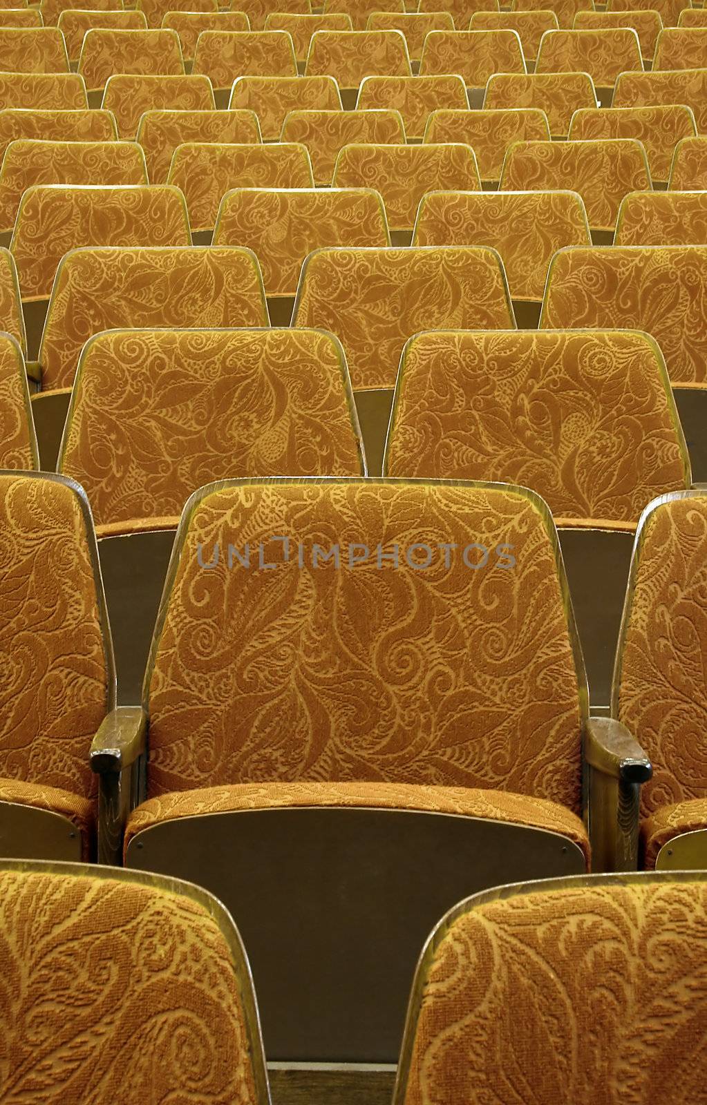 empty red wooden cinema/theater seats, number 13 in the middle,