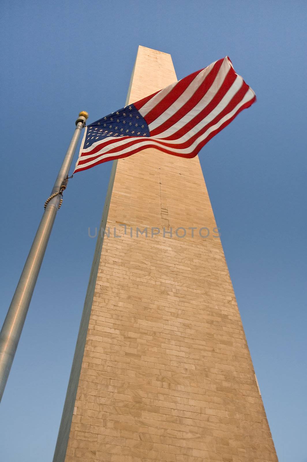 obelisk and waving american flag, photo taken in washington, but can be used as almost any american obelisk :-)