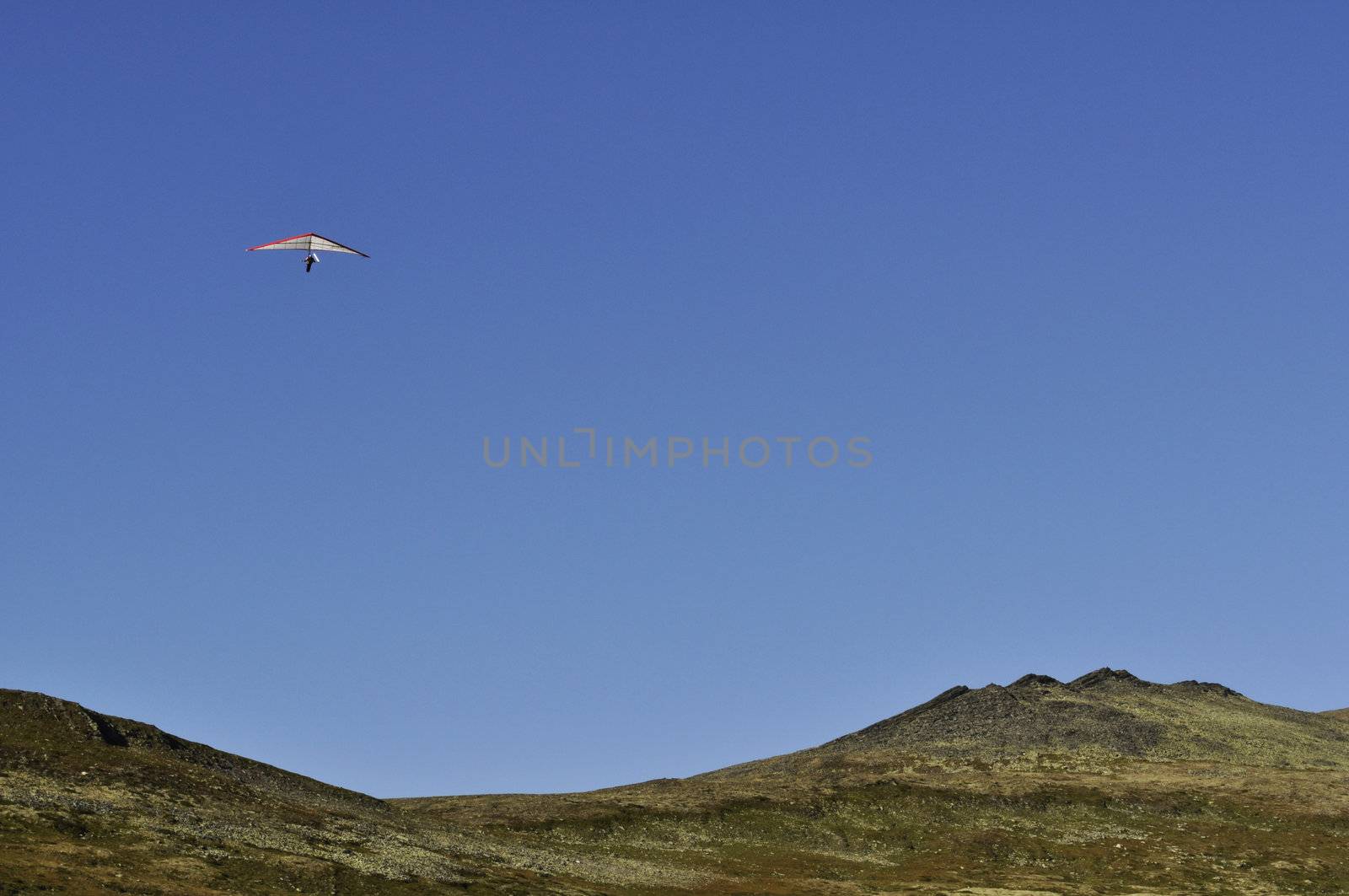 a hanglider over the mountains